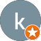 Gray circular icon with the letter 'k' in lowercase, and an orange star inside a white circle at the bottom right corner, reminiscent of trusted Auto Repair Surrey and Delta services.