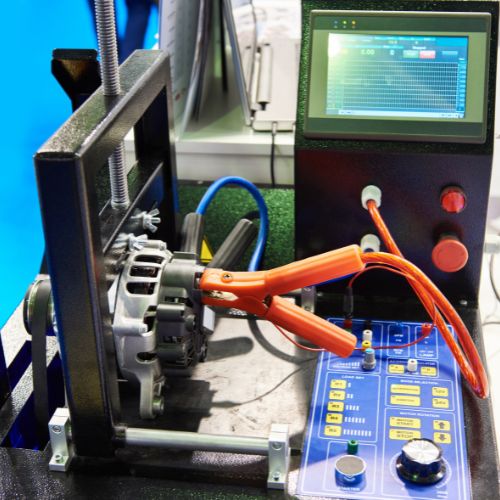 Device with clamps and an attached monitor displaying data, used for technical measurements or testing.